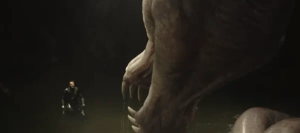 巨大な怪物(ドラゴンスネーク)と水辺で組み合うマンダロリアン